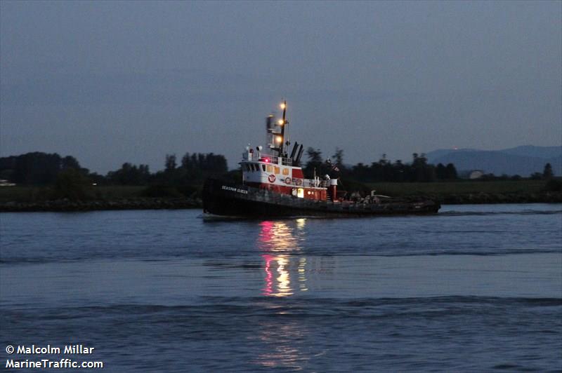 Seaspan tugboat at dusk with three masthead lights.